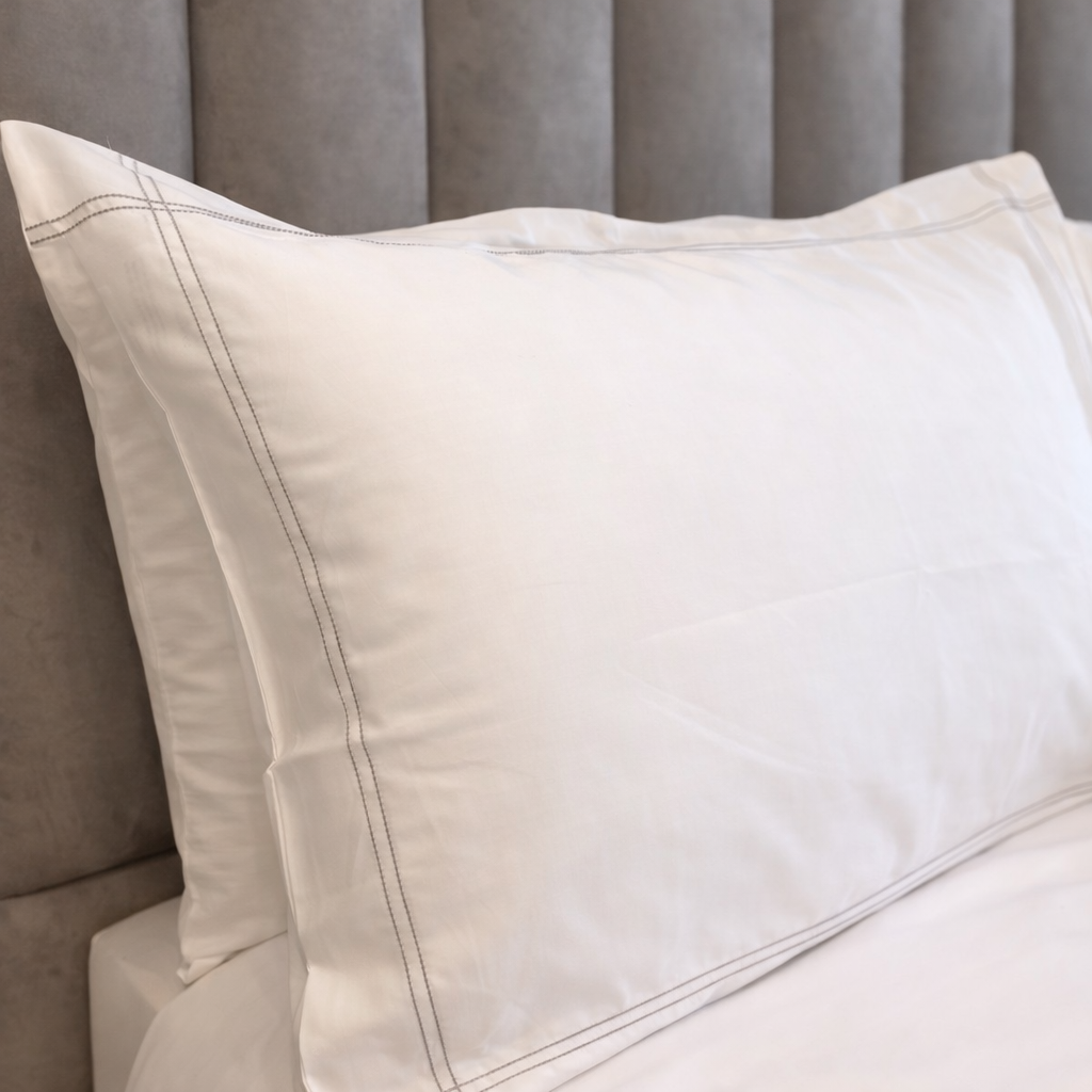 Close-up of beige pillows on a gray sofa