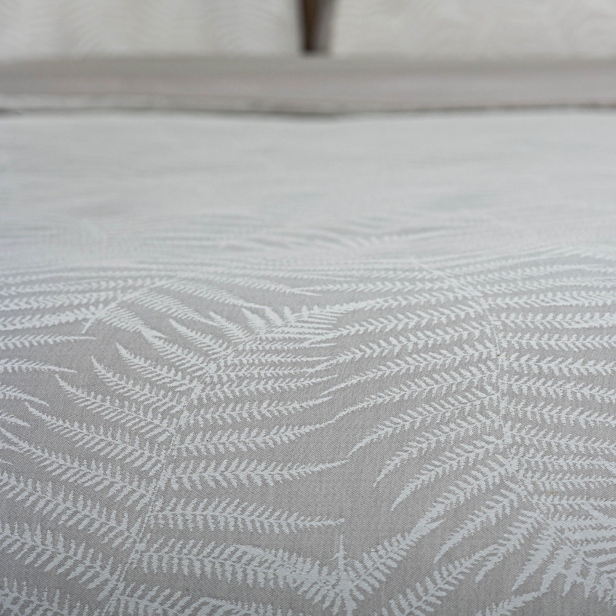 Textured fabric with leaf pattern on a neutral background