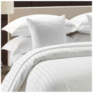 A white duvet cover with a striped pattern, displayed on a bed with matching white pillows.