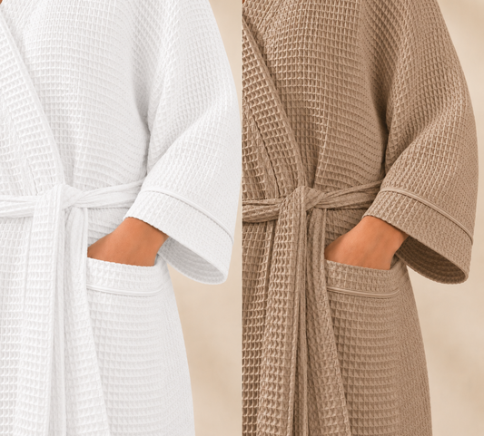 Two waffle-textured robes, one white and one beige, on a neutral background.