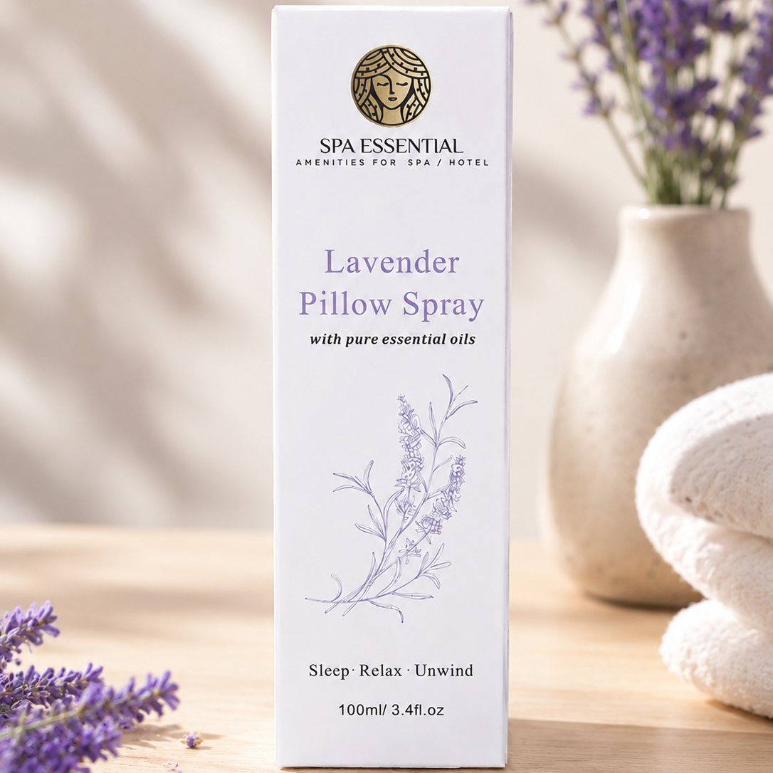 Spa Essential Lavender Pillow Spray box with lavender flowers and towels in the background